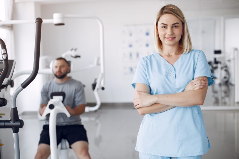 Patient has a rehabilitation in physiotherapy clinic. Doctor in a uniform.