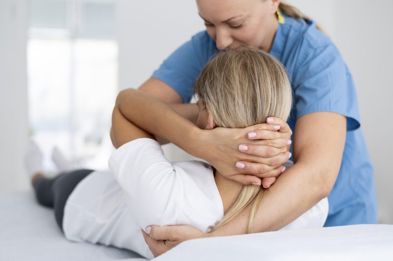 physiotherapist-helping-young-female-patient